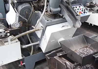 Fastener manufacturing machine used for industrial fastener production.