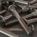 Bulk pile of shiny zinc plated carriage bolts for woodworking and structural fastening