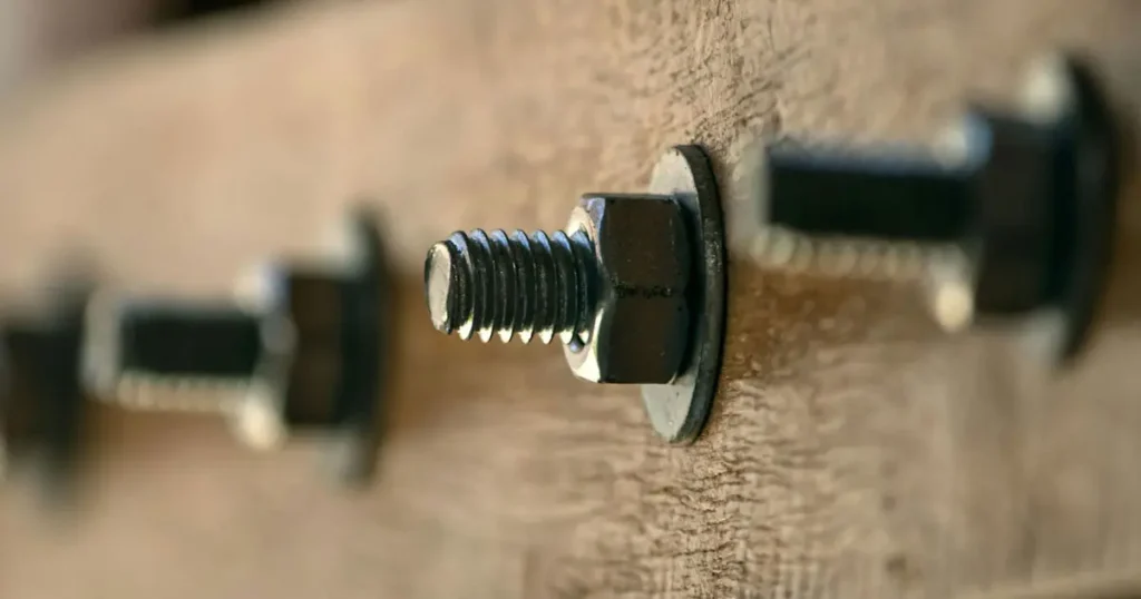 hex bolt installed with flat washer and hex nut on wooden structure