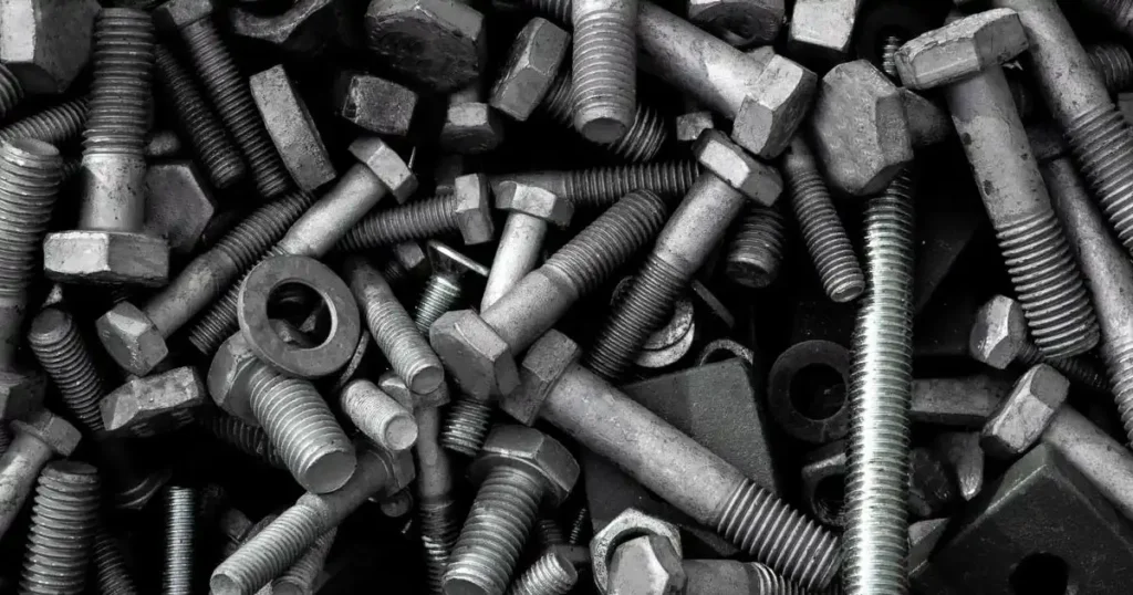 Assortment of industrial metal bolts nuts and washers for structural machinery assembly