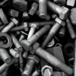 Assortment of industrial metal bolts nuts and washers for structural machinery assembly