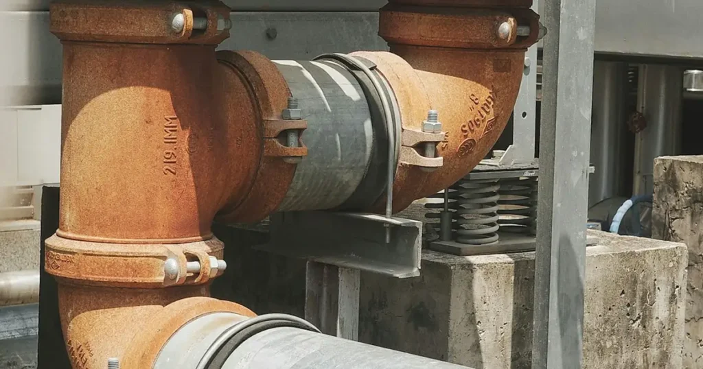 Stainless steel U bolt securing a pipeline to a support structure in an industrial facility