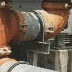 Stainless steel U bolt securing a pipeline to a support structure in an industrial facility