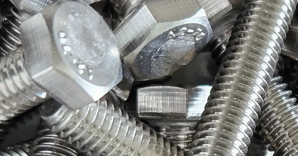 Bulk pile of stainless steel hex bolts for industrial fastening applications