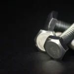 Zinc plated steel hex head bolts on black background for machinery assembly